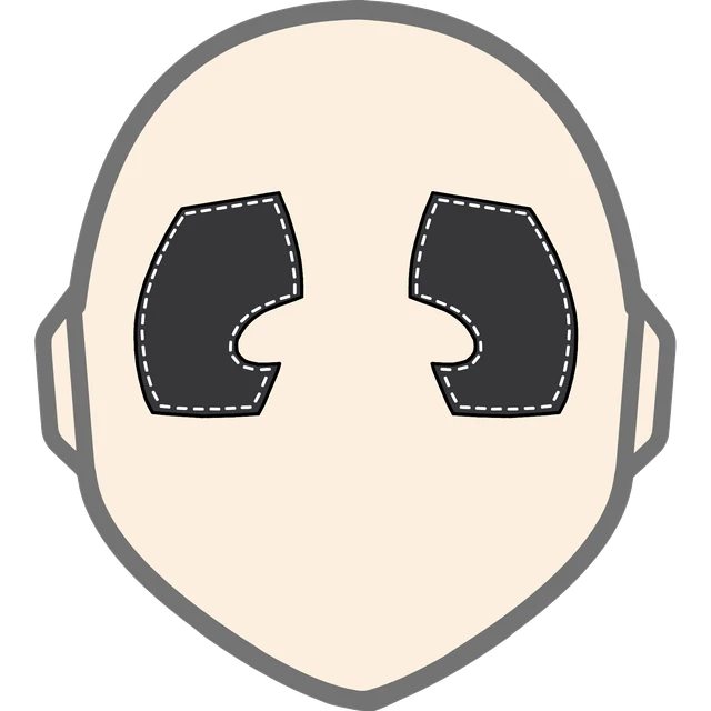 The official Golli Goth face: a bald cream head with small ears and two black stitched eye patches